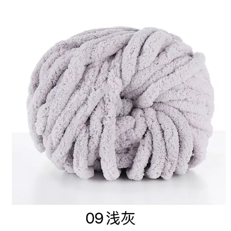 A ball of light gray chunky acrylic yarn used for knitting and crochet