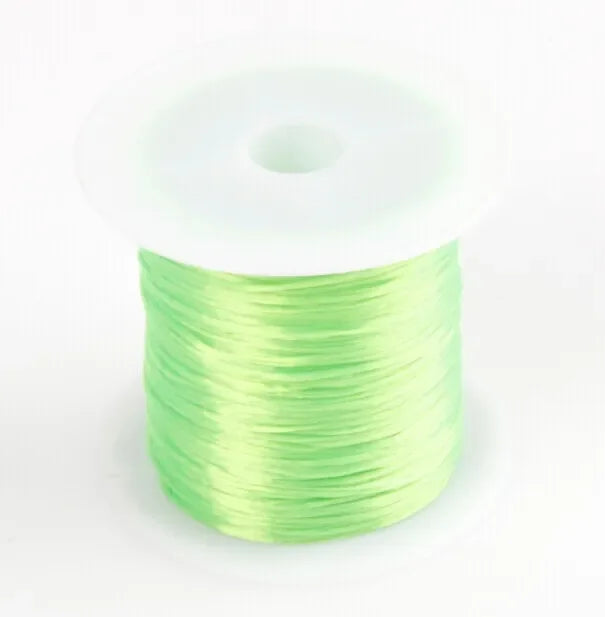 A spool of 10m multicolour elastic cord used for beading and jewelry making.