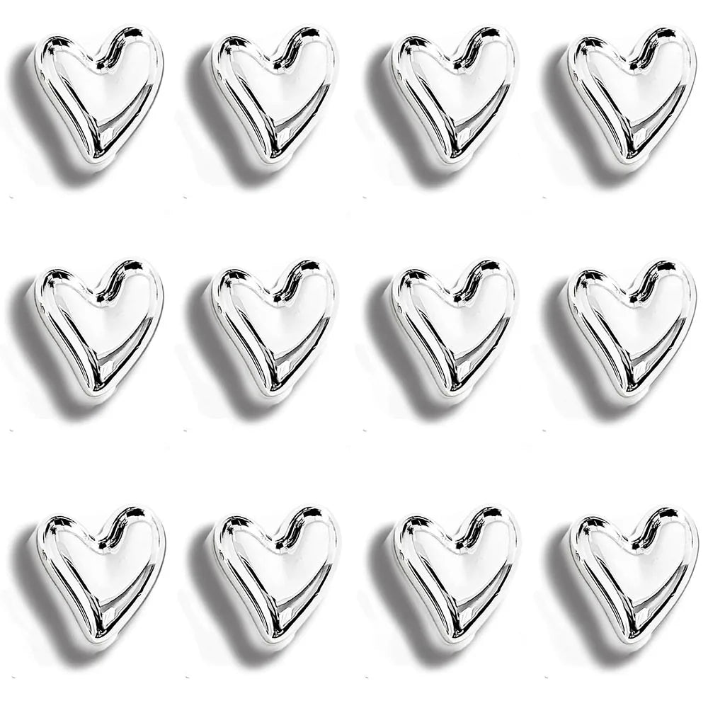 A set of twelve shiny silver heart-shaped refrigerator magnets arranged in a grid.
