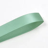 A roll of sage green double face satin ribbon.