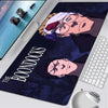 A dark blue gaming mouse pad featuring a stylized illustration from The Boondocks