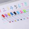 A set of colorful flexible magnetic dry erase markers with various tips and colors laid out on a white sheet.