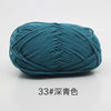 A ball of teal blue 4-ply milk cotton yarn for knitting and crochet.