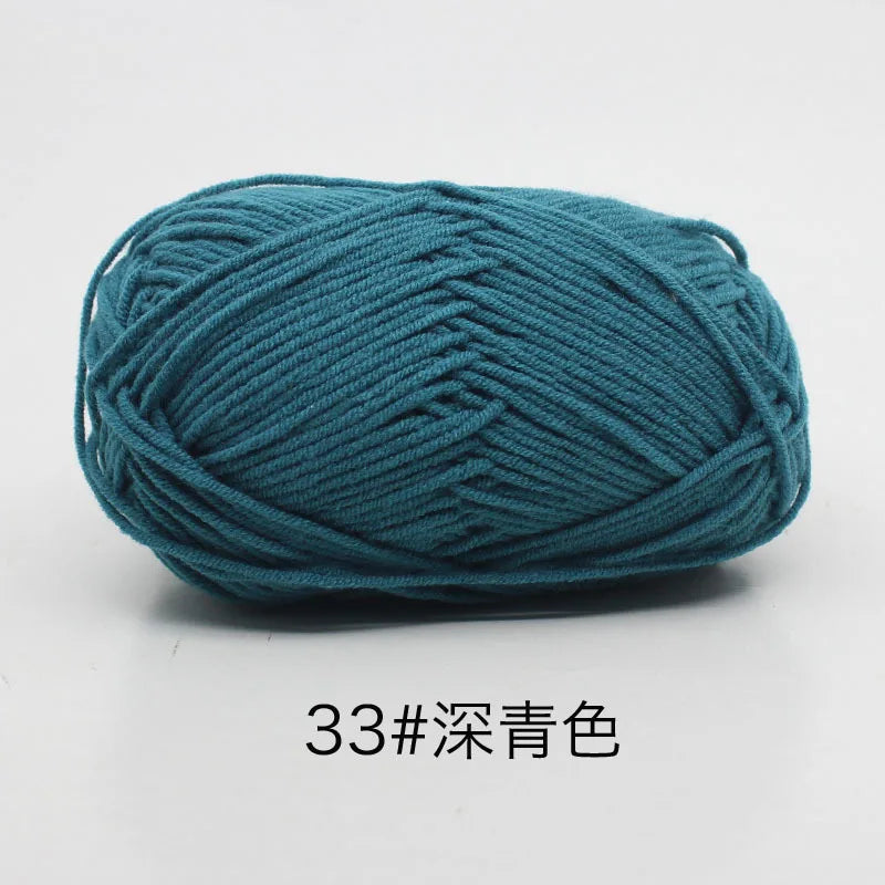A ball of teal blue 4-ply milk cotton yarn for knitting and crochet.