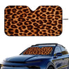 A leopard print car windshield sunshade placed on a blue car windshield.
