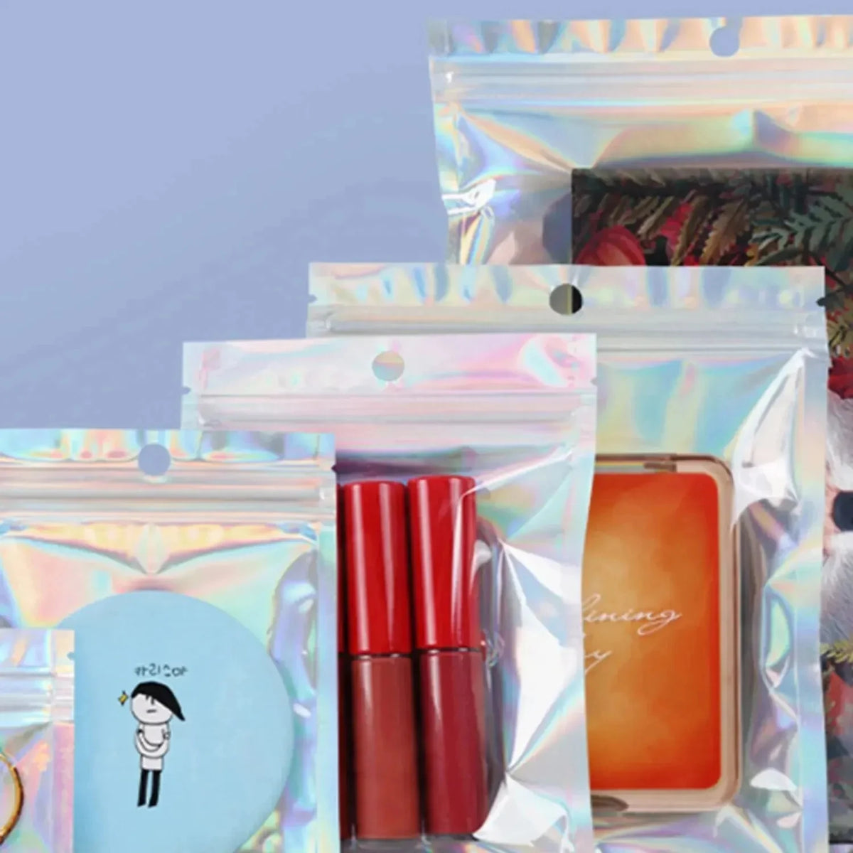 A display of holographic rainbow self-sealing bags with clear windows containing various products.