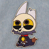 An embroidered patch of a stylized white cat dragon head with large yellow eyes and dark markings.