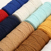 A collection of various colored macrame cord in different thicknesses and lengths for crafting.