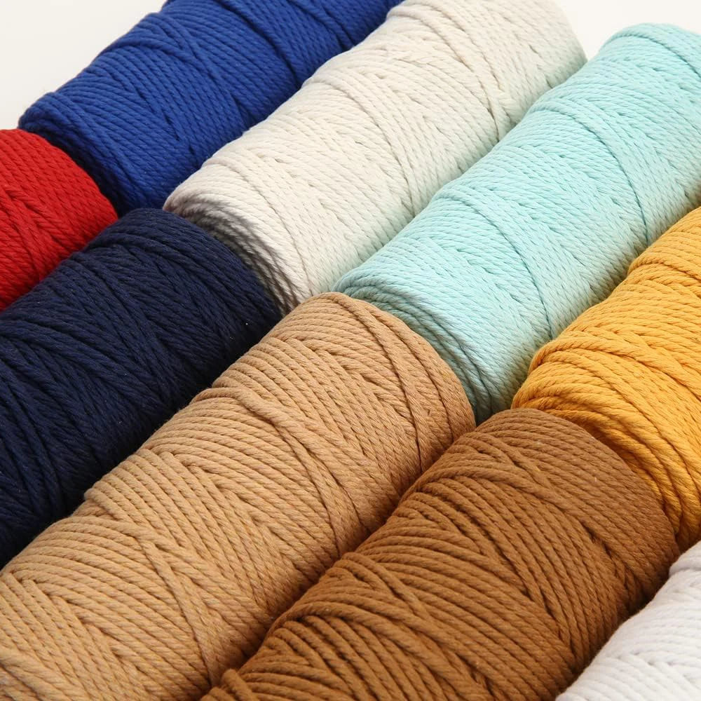 A collection of various colored macrame cord in different thicknesses and lengths for crafting.
