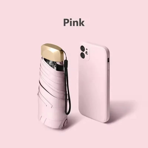 A pink compact UV-protective pocket umbrella is shown against a light pink background.