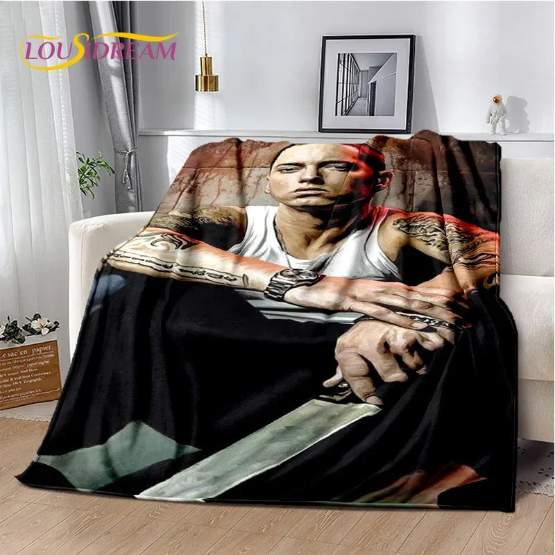 A throw blanket featuring a portrait of Eminem and 2Pac in a gritty style with a knife visible.