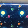 Blue space wallpaper featuring colorful planets and stars for a peel-and-stick product.