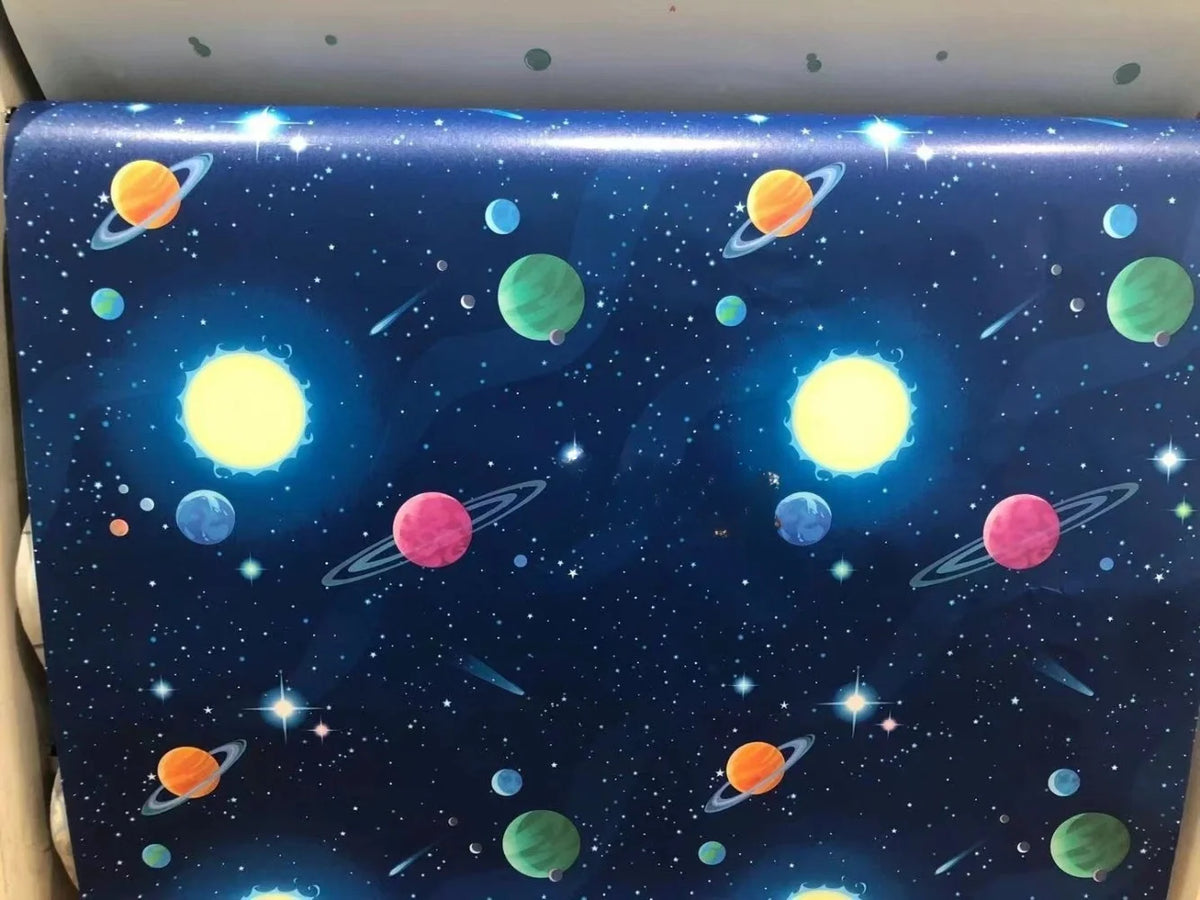 Blue space wallpaper featuring colorful planets and stars for a peel-and-stick product.