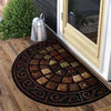 A vintage stone tile doormat with an ornate border and geometric pattern rests on a wooden floor next to a window.
