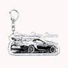 A silver metal keychain featuring a detailed silhouette of a modern sports car.