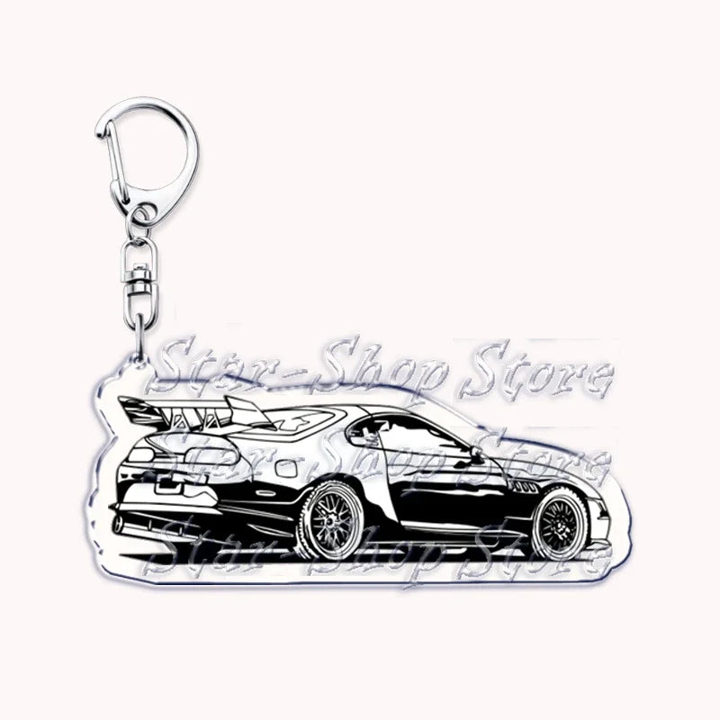 A silver metal keychain featuring a detailed silhouette of a modern sports car.