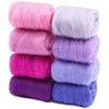 A stack of eight colored wool roving packs for needle felting, including pink, purple, and blue shades.