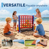 Children playing with a red and blue outdoor game set featuring a basketball hoop and ring toss on a sandy beach.