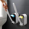 A hand is using a white cleaning pad to remove a disposable toilet cleaning pad from a toilet.