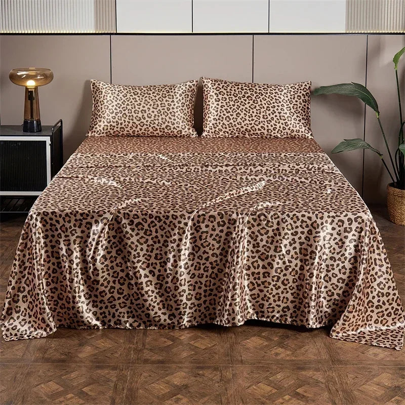 Luxury satin leopard print bedding set displayed on a bed with modern headboard and dark wood floor.