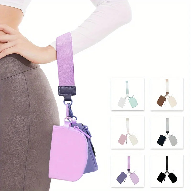 A pink detachable wristlet wallet with a purple strap and zippered coin pouch shown against a person's torso.