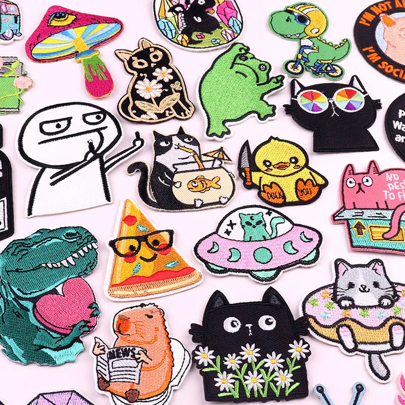 A collection of colorful cartoon cat embroidery patches featuring various cats and related characters.