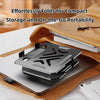 A compact carbon steel tablet stand is shown folded on a leather surface next to a laptop.