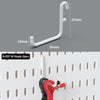 A white M hook is shown next to a measuring scale, with several colored cables visible on a pegboard organizer.