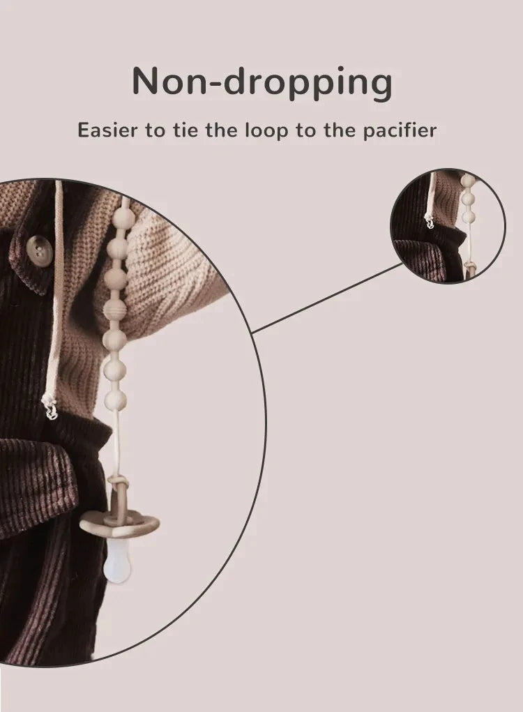 Close-up of a silicone pacifier clip with a loop being tied to a garment for easier use.