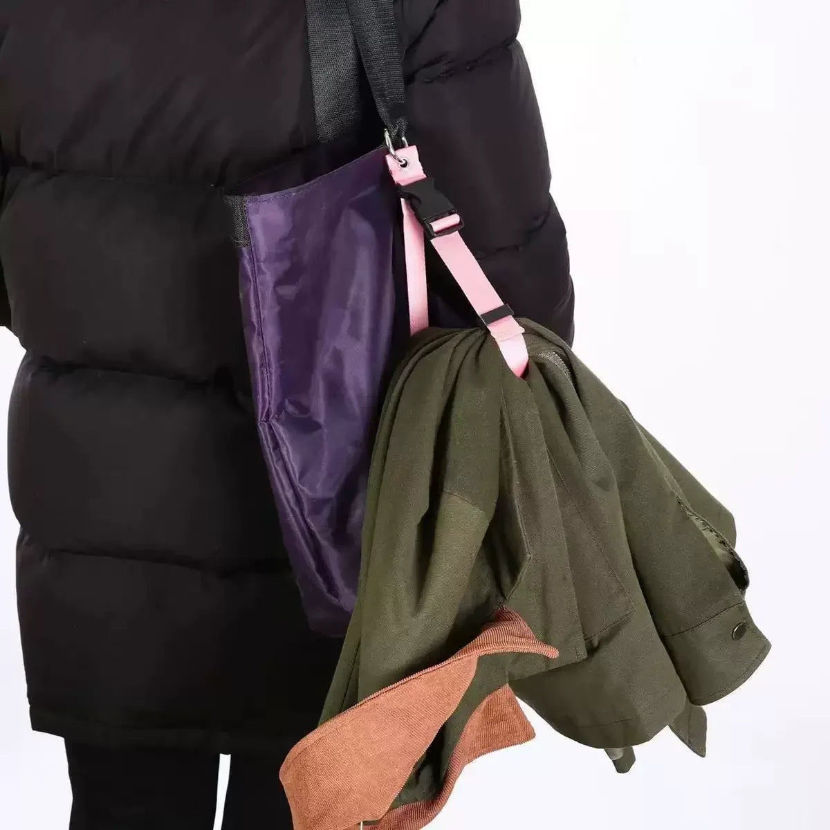 A dark green luggage hanging strap attached to a black puffer jacket.