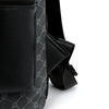 Close-up of a black PU leather backpack strap and detail with a subtle gray pattern.