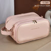 A light pink waterproof cosmetic bag with a zipper and leather strap resting on a brown surface.