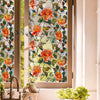 Close-up of floral stained glass window film featuring orange and pink roses on a window pane.
