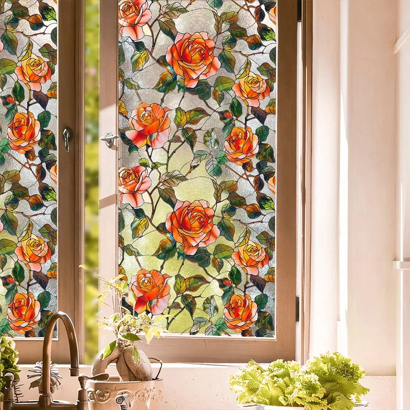 Close-up of floral stained glass window film featuring orange and pink roses on a window pane.
