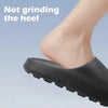 A close-up of a black cloud thick-soled EVA slide on a foot, emphasizing the sole design.