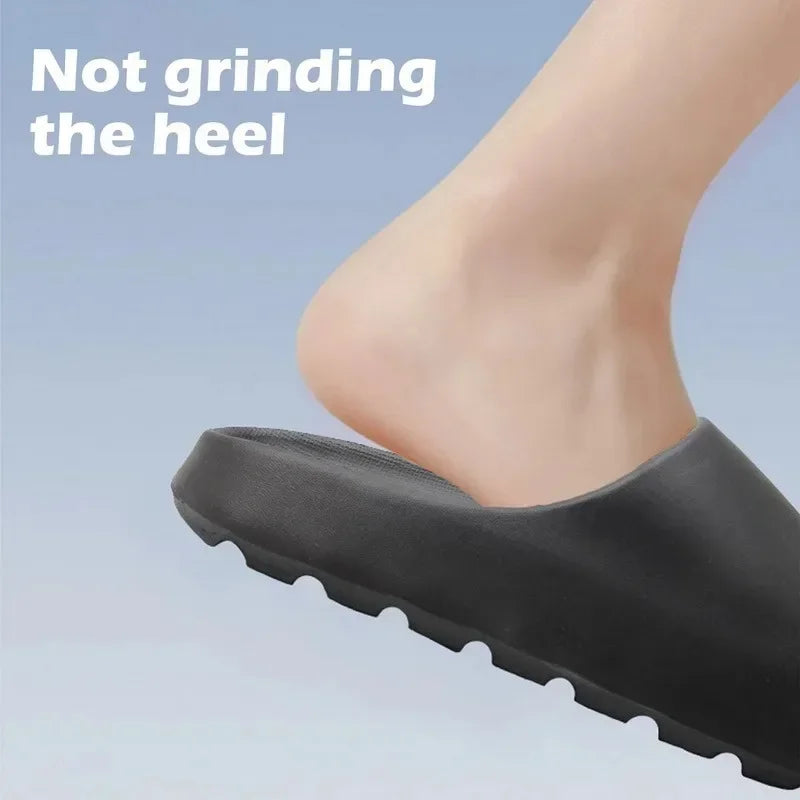 A close-up of a black cloud thick-soled EVA slide on a foot, emphasizing the sole design.