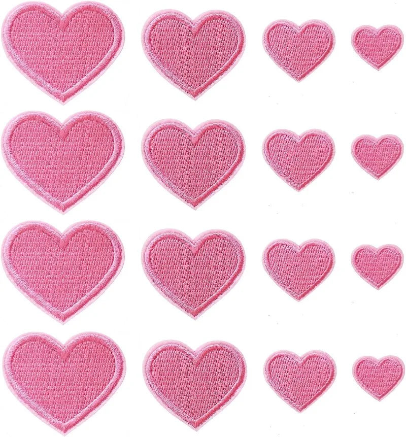 A collection of twenty-four pink heart-shaped iron-on patches in various sizes and textures.