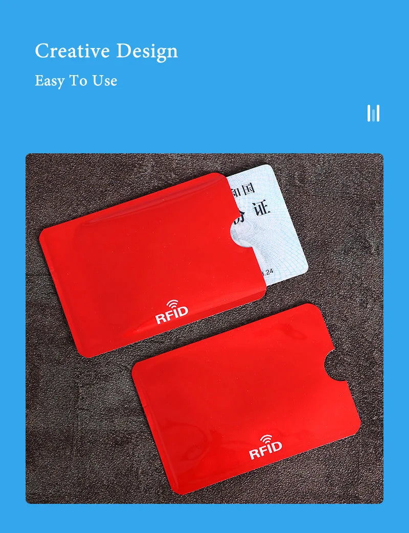 Two red RFID blocking card sleeves are shown on a dark surface next to a white identification card.
