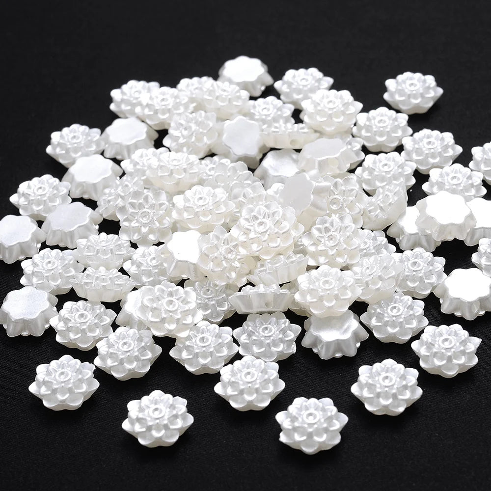 A pile of 100 white acrylic pearl spacer beads for jewelry making.
