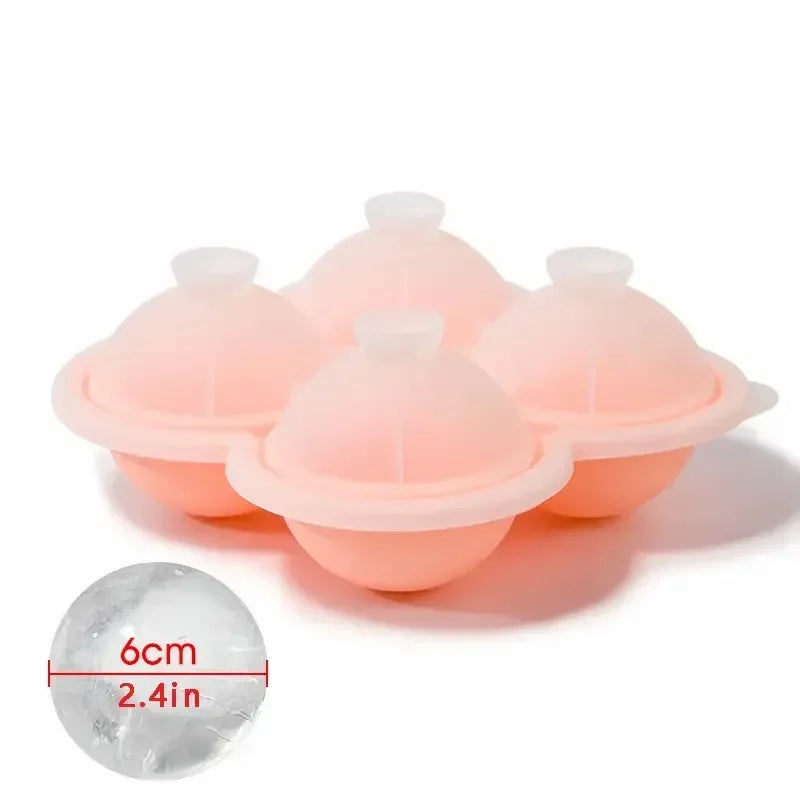 A set of pink silicone ice cube trays and a single clear ice cube measuring 6cm or 2.4 inches.