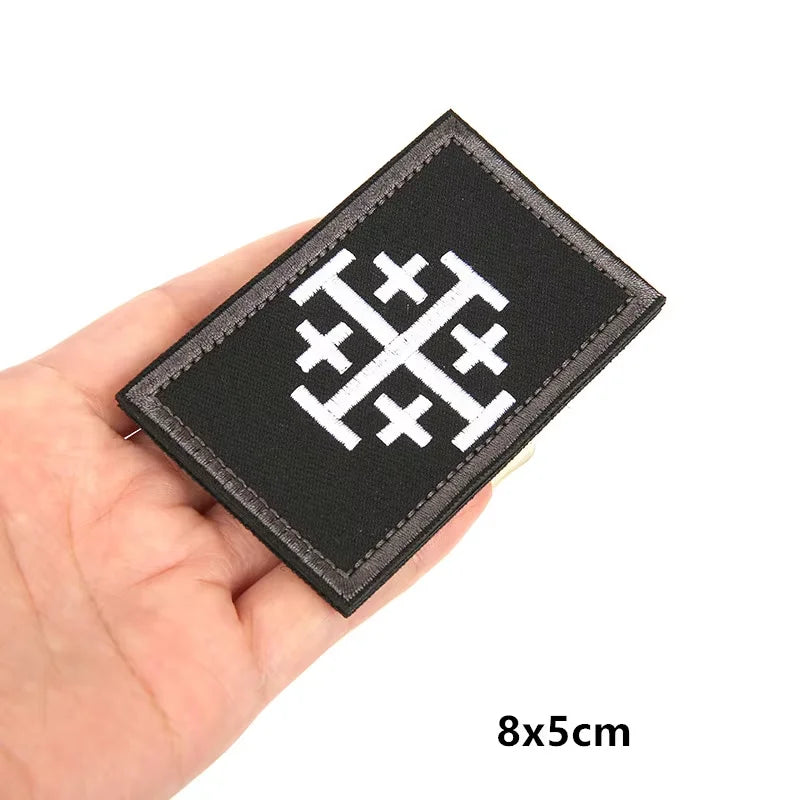 Black embroidered patch featuring a white Knights Templar cross design with hook and loop backing