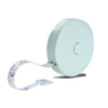 A light mint green flexible soft tape measure with dual-sided markings and a white strap.