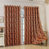 A pair of patterned, reddish-brown tree bark jacquard blackout curtain panels hanging in a light-colored room.