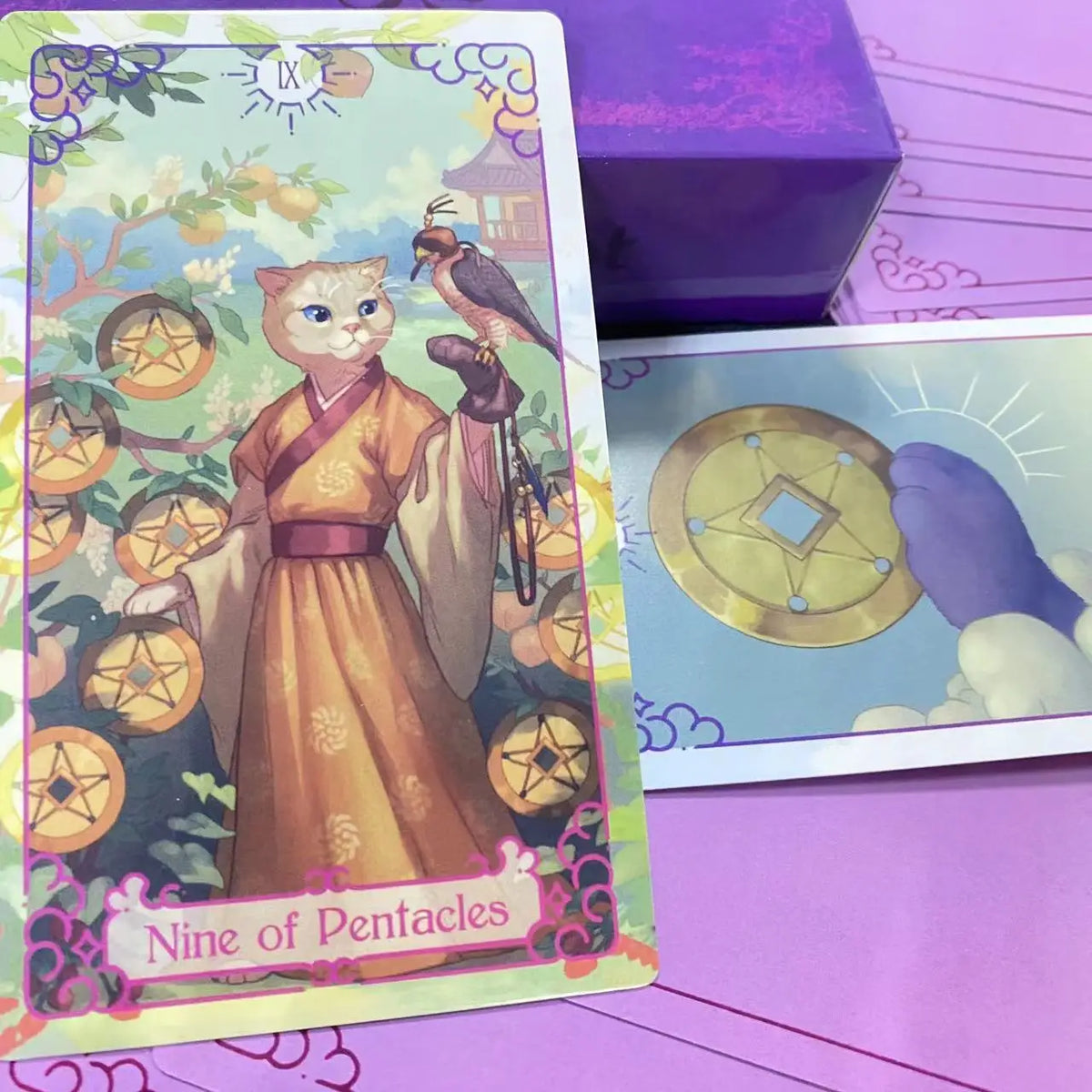 A tarot card featuring a feline figure in an orange robe surrounded by gold coins and foliage.