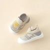 A pair of beige and gray breathable soft-sole baby shoes with non-slip grip shown from above.