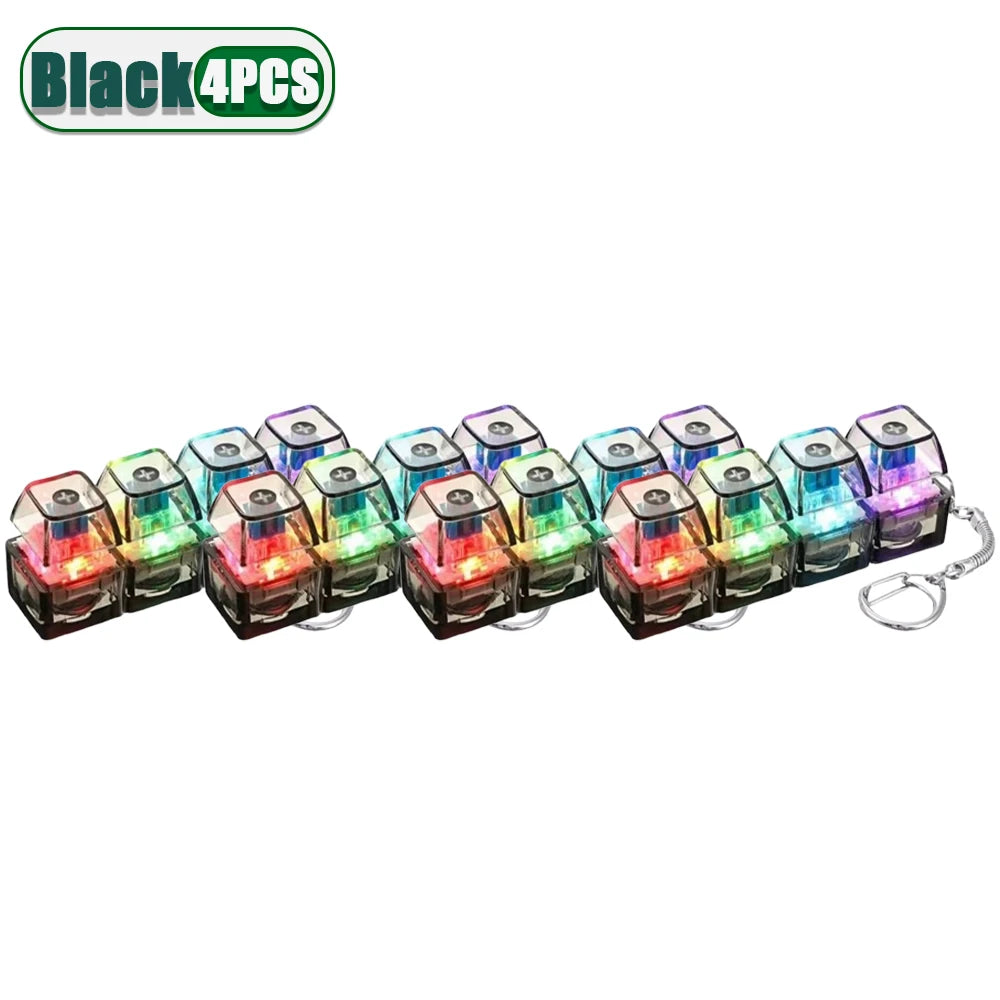 Four black LED clickable fidget keychains with keyboard designs.