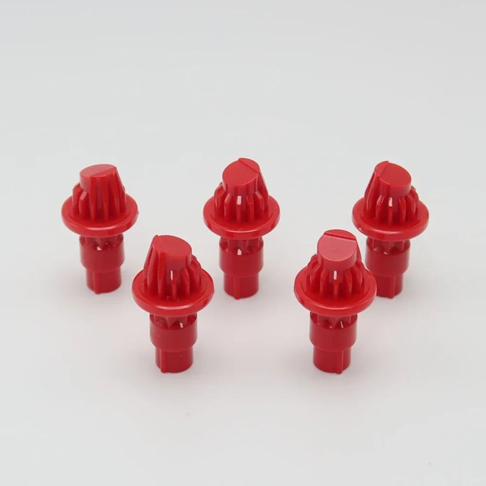 A set of five red replacement drivers for a Battling Top, used to fix or replace the top mechanism.