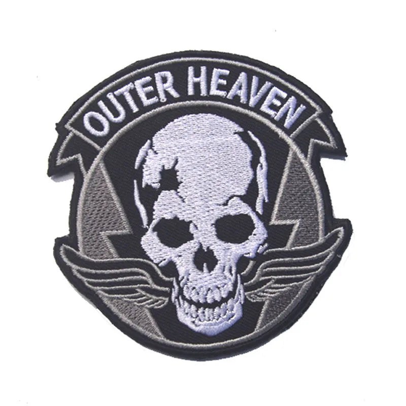 Black and gray embroidered patch with the text OUTER HEAVEN surrounding a skull and wings design