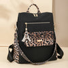 Schwarzer Mode-Reiserucksack mit Leopardenmuster-Farbpanel und goldenen Details.