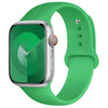 A green silicone sport band for an Apple Watch displayed on a white background.